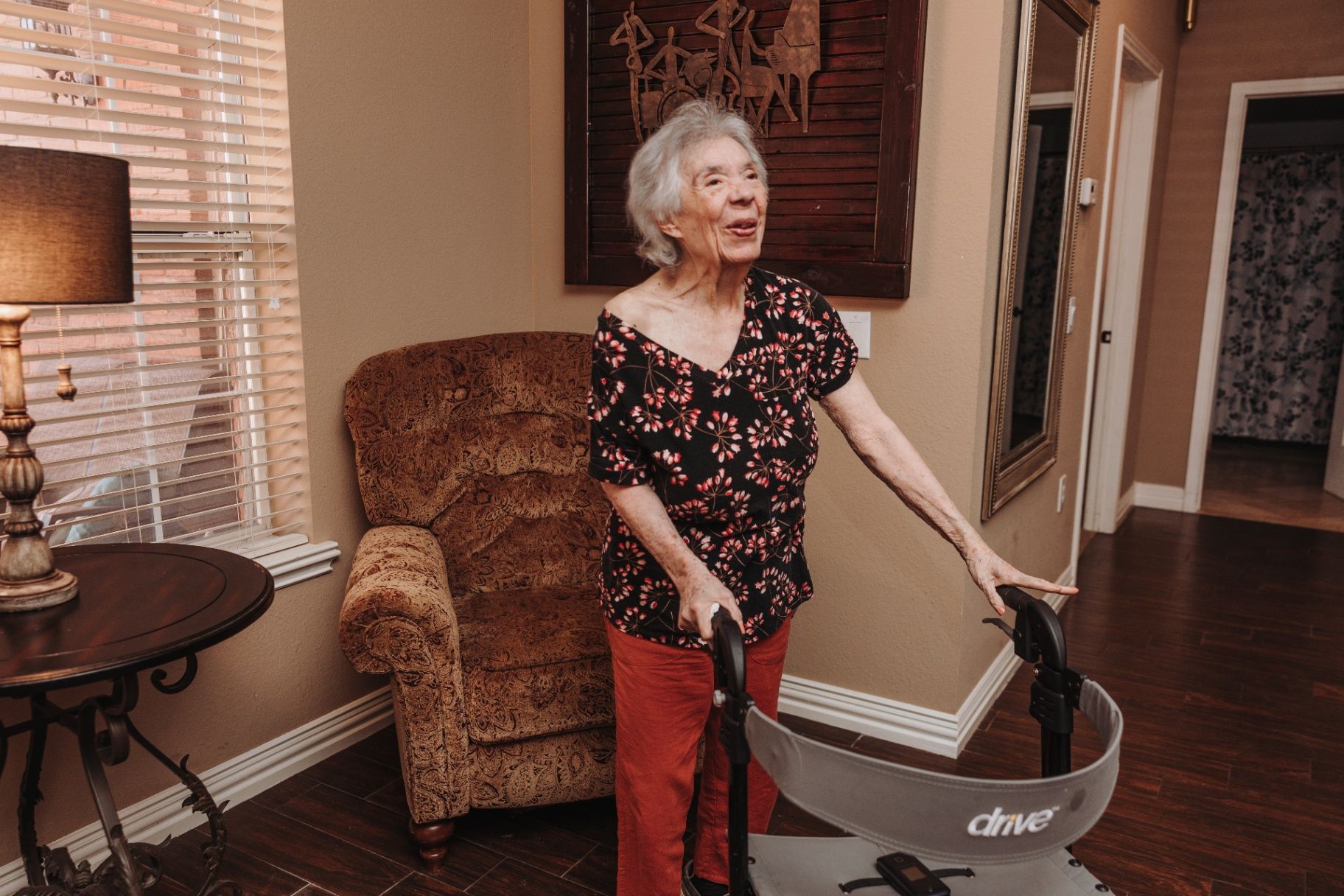 A resident using a walker indoors