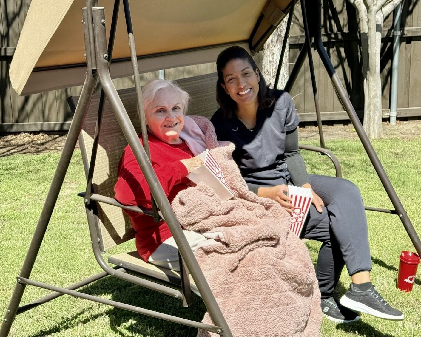 A caregiver and resident spending time outside