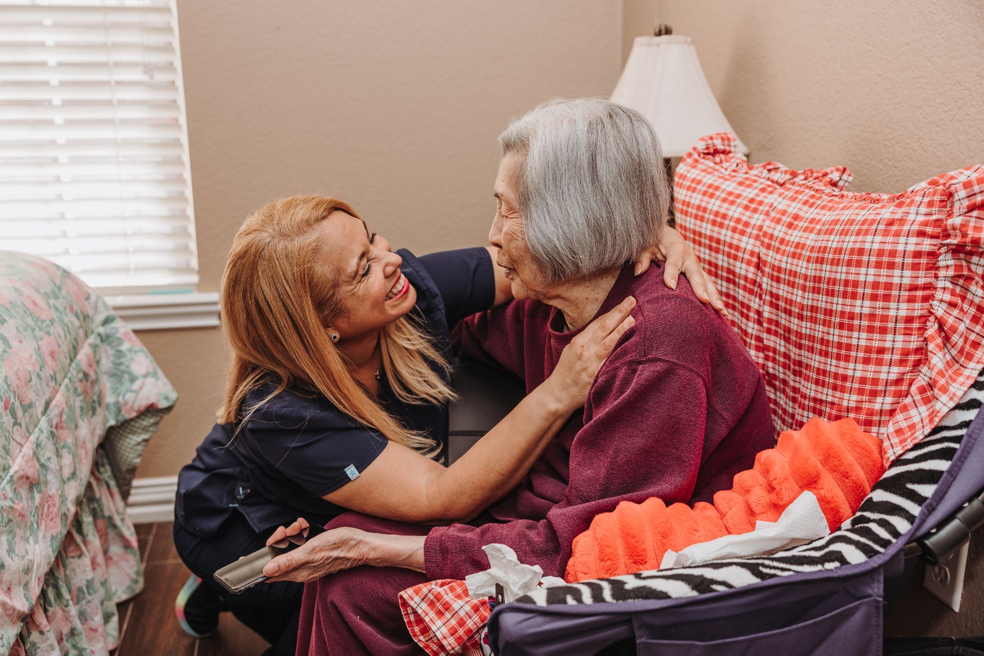 A caregiver embracing a resident at home