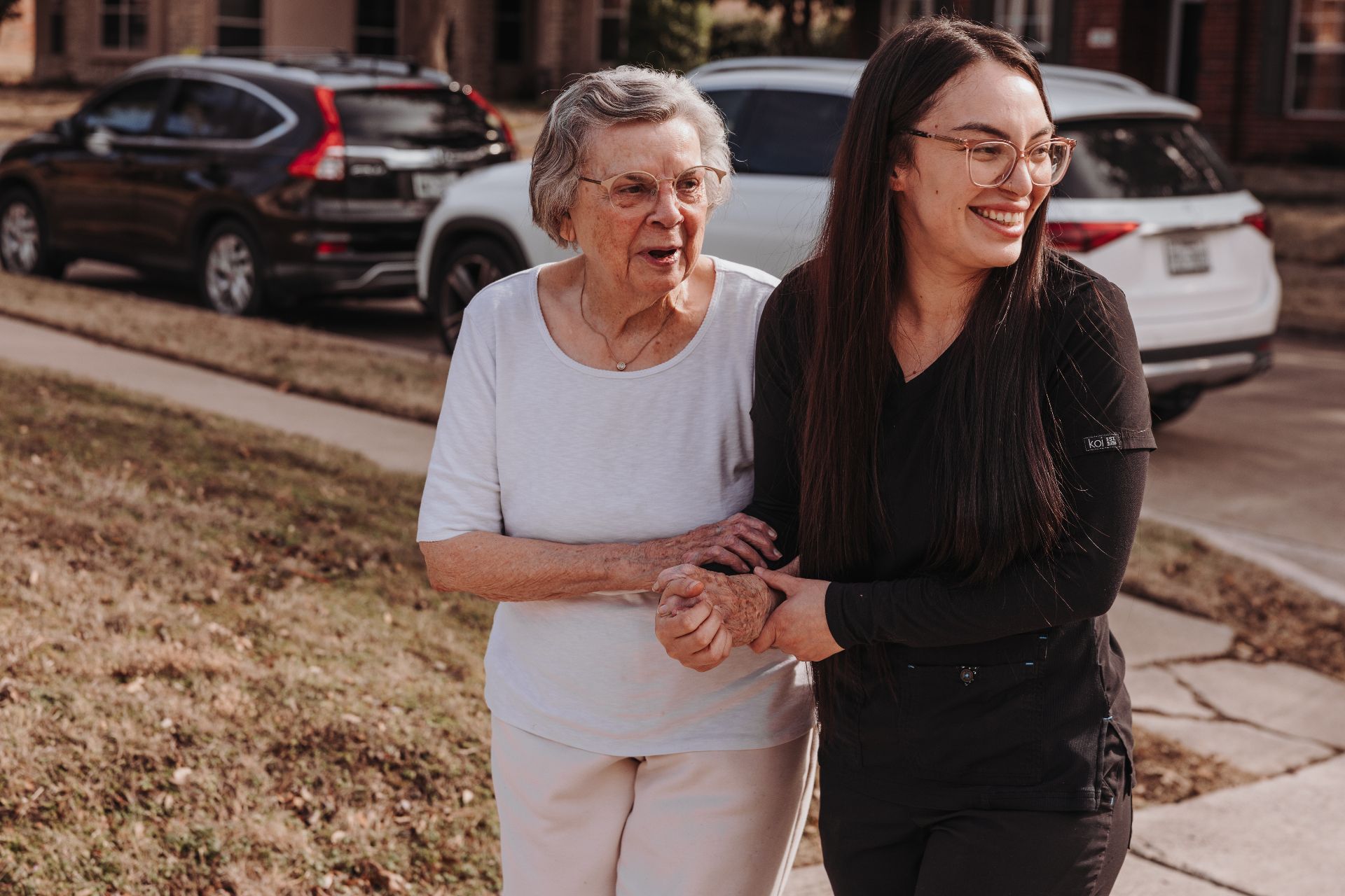 A resident and caregiver together outdoors